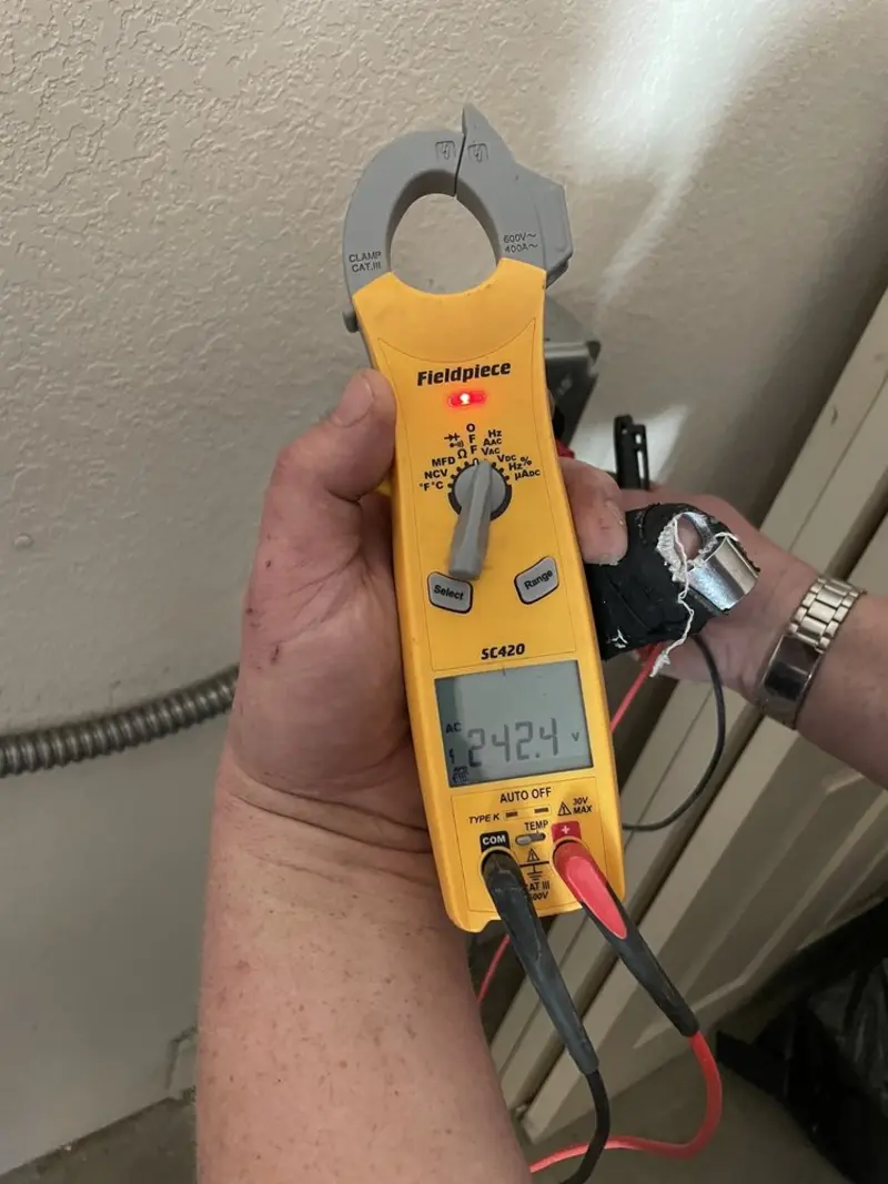 Voltage testing with clamp meter during Outlet Installation in Windsor